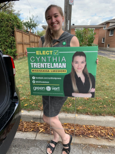 Cynthia Trentelman holds a lawn sign